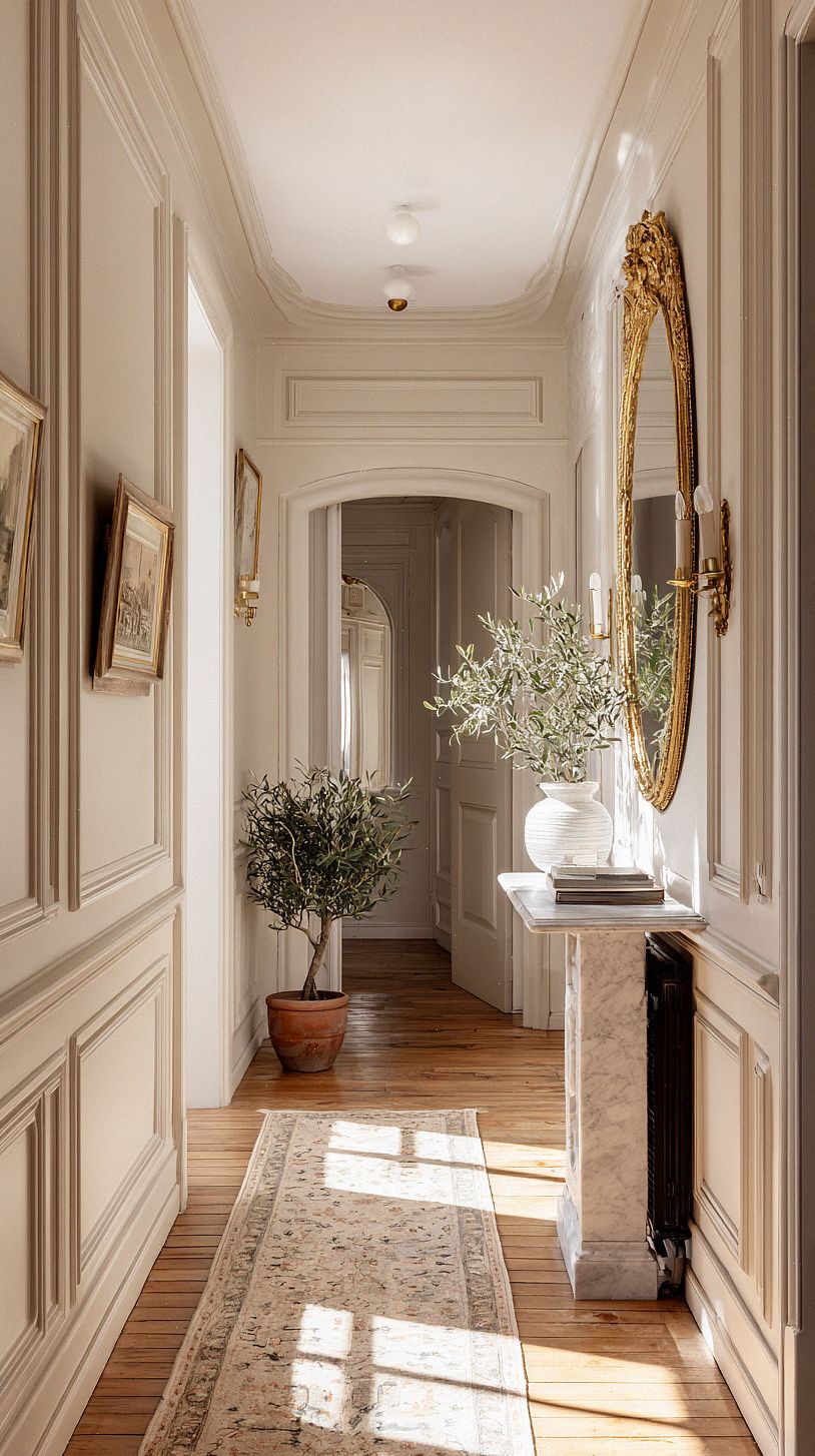 a-narrow-french-hallway-with-muted-neutral-walls-in-warm-gre
